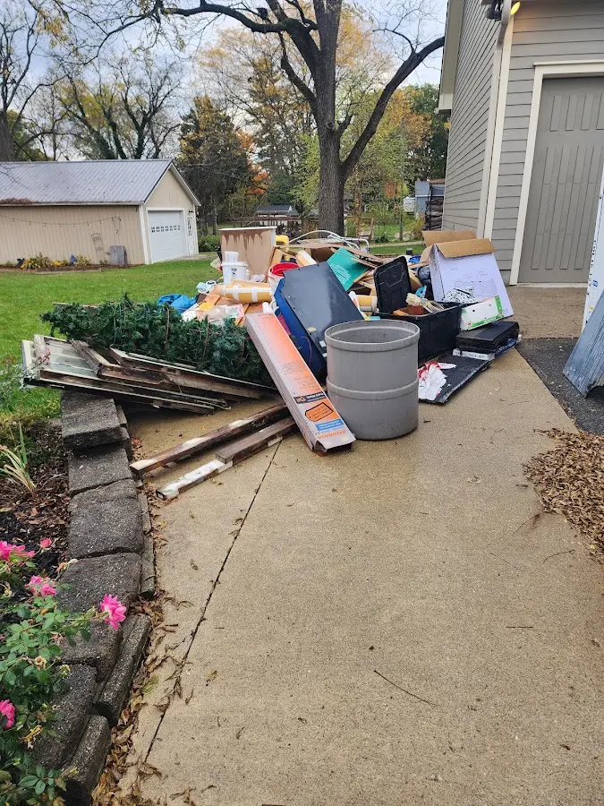Dumpster being loaded with debris for 10 Yard Dumpster Rental in Feather Sound